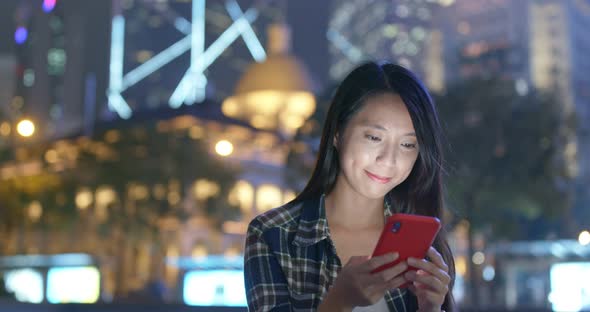 Woman Look at Cellphone in City at Night