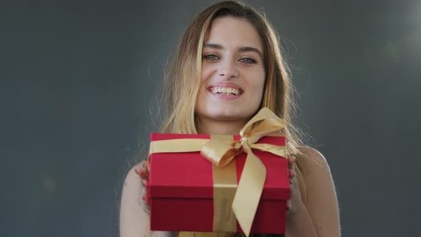 Female Studio Portrait Gray Background Young Beautiful Happy Generous Girl Woman Holding Christmas