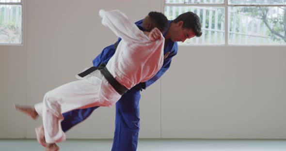 Judokas training by doing a randori on the judo mat