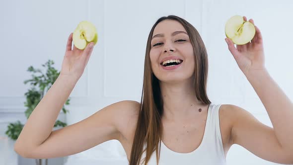 Beautiful Young Woman with Apple on Eyes