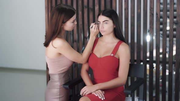 Beautiful Young Caucasian Woman Makeup Artist Applies Makeup