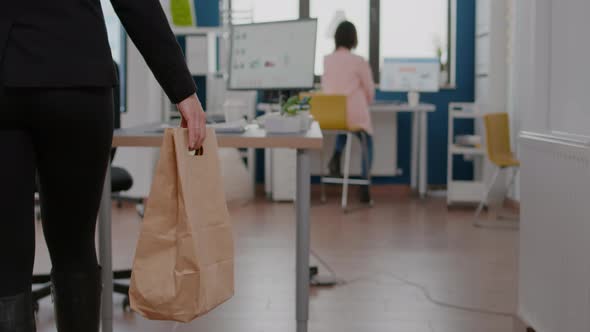 Businesswoman Holding Paper Bag with Takeaway Food Meal Order Putting on Desk