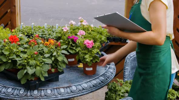 Female florist writing on clipboard