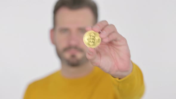 Portrait of Middle Aged Man Holding Bitcoin Crypto Currency
