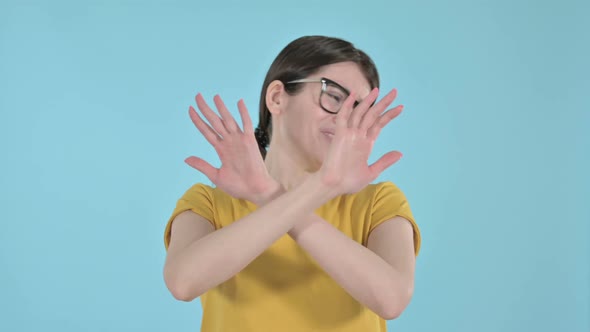 Young Woman Saying No By Hand Gesture on Purple Background