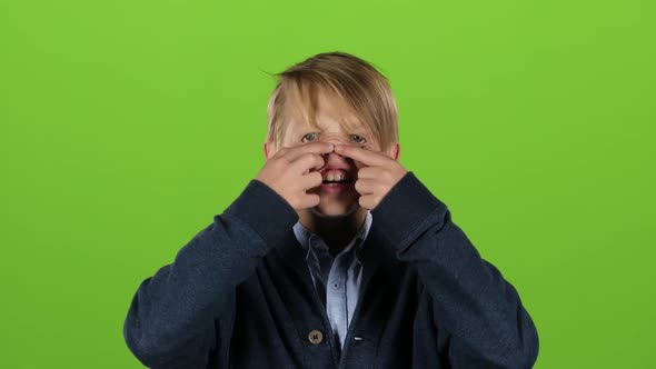 Child Is Making Grimaces. Green Screen