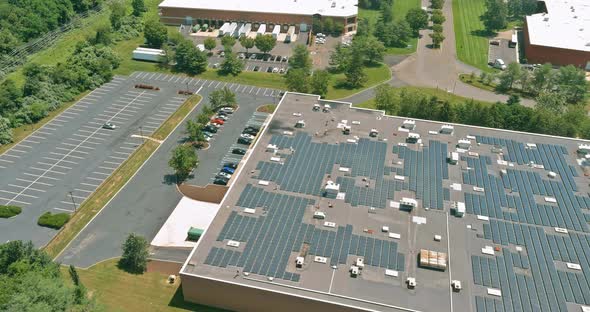 Panoramic aerial view solar panel energy on the an industrial warehouse rooftop