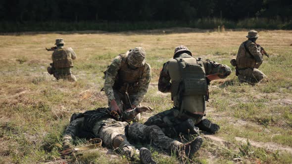 A Military Man Uses a Medical Tourniquet to Stop Bleeding in First Aid and Prevent Bleeding on Hand