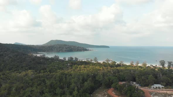 Exotic green lush hills that meet the turquoise sea in Saracen Bay in Koh Rong Sanloem, Cambodia