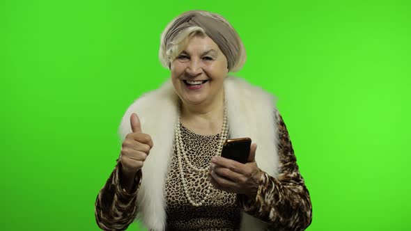 Elderly Caucasian Grandmother Woman Using Smartphone for Shopping. Chroma Key