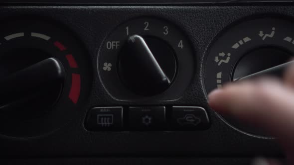 The Woman Turns on the Fan and Presses the Button for the Internal Ventilation in the Car