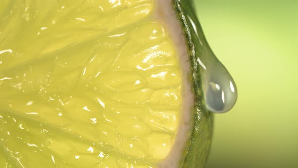 Drop of Water Flows Down the Surface of a Ripe Juicy Lime Slice