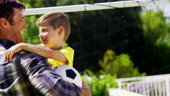 Father embracing his son in park