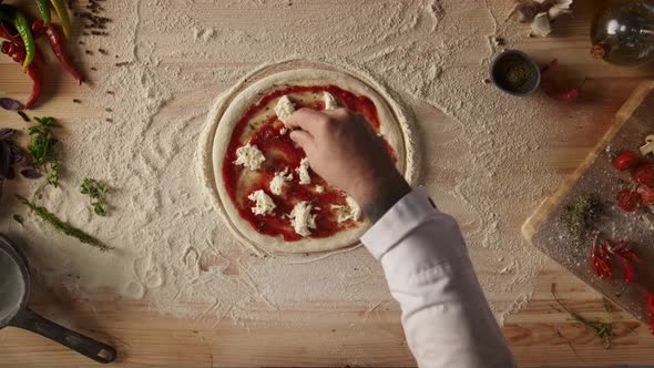 Man Making Homemade Pizza Pepperoni Italian Food Dinner on Kitchen Table Board