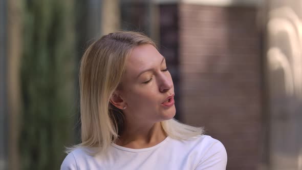 Portrait of Pretty Young Woman Removes a Protective Medical Mask From the Face and Breathes Fresh