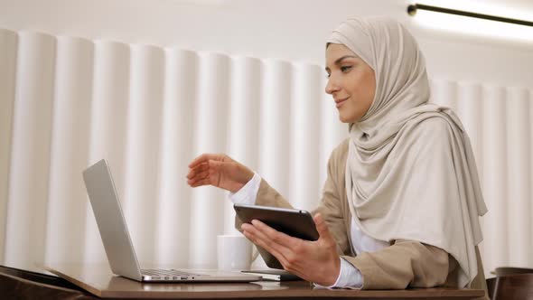 Muslim Woman on Remote Working Online Education or Video Conversation in Caffe