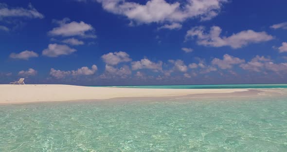 Wide angle above travel shot of a sandy white paradise beach and turquoise sea background in high re