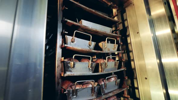 Rotary Furnace with Meat Is Getting Closed By an Employee