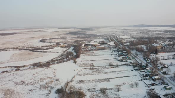 View From a Drone to the Ground Covered with Snow at the Morning