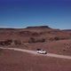 Car Driving on Gravel Road in Aerial Desert - VideoHive Item for Sale