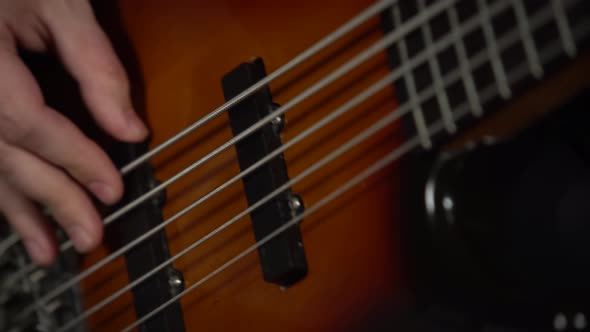 Professional Musician Playing on Electric Guitar in a Dark Studio with Smoke and Neon Lighting