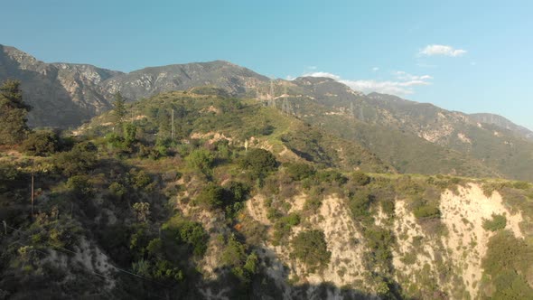 Aerial of Power Lines on a Verdant Mountain