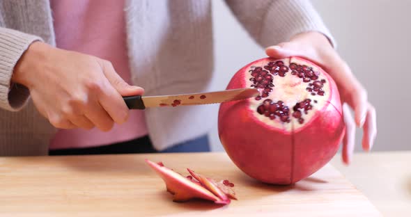Cutting red pomegranate 