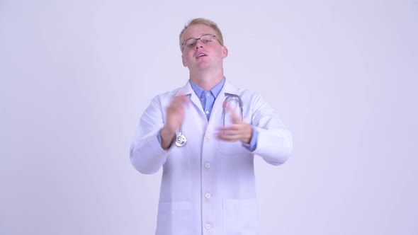 Happy Young Blonde Man Doctor Clapping Hands