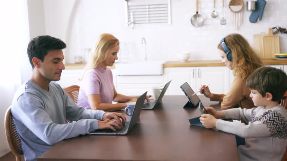 Happy Family Using Electronic Device at Home