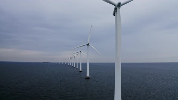 Scenic View of the Ocean and Windmills Against Clear Sky