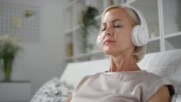 Woman in Headphones Enjoying Music at Home