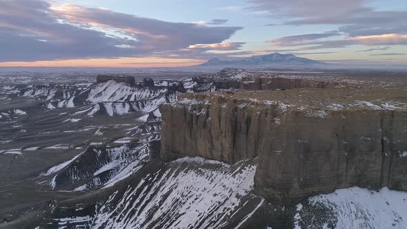 Aerial view rotating around viewpoint with vehicles on top of cliff