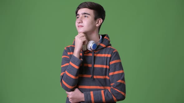 Young Handsome Iranian Teenage Boy Against Green Background