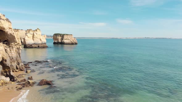 Algarve stunning Limestone Cliffs scattered through Lagos Coastline, Portugal - Aerial Fly-over shot