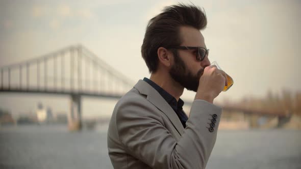 Businessman Drinking Tea On Vacation. Italian Man Looking At Bridge. Businessman In Sunglasses.