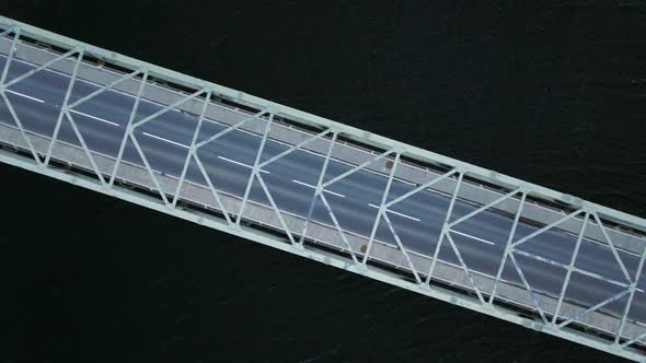 Bird's Eye View of a Bridge Spanning a Fast Flowing Dark River