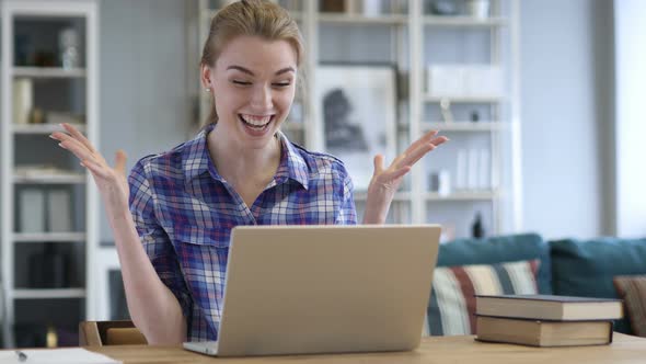 Excited Woman Celebrating Success, Working on Laptop