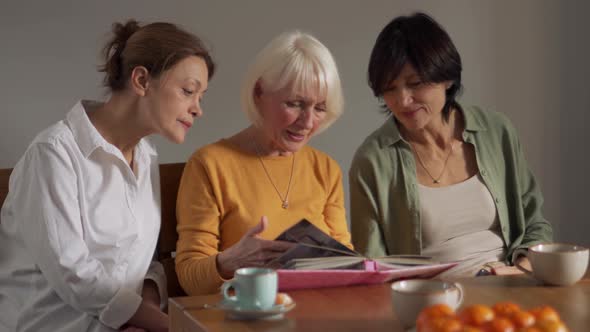 Confident mature women looking at old photos