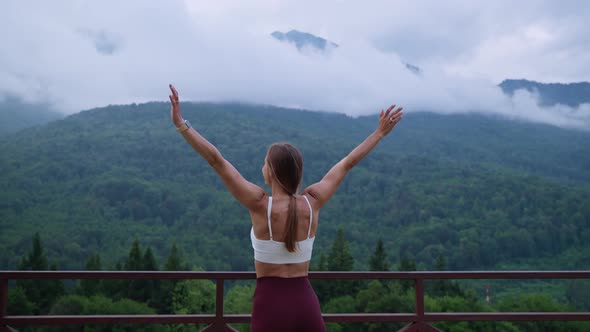 Enjoying and Admiring Beautiful Nature in Mountains in Summer Rear View of Woman with Lifted Hands