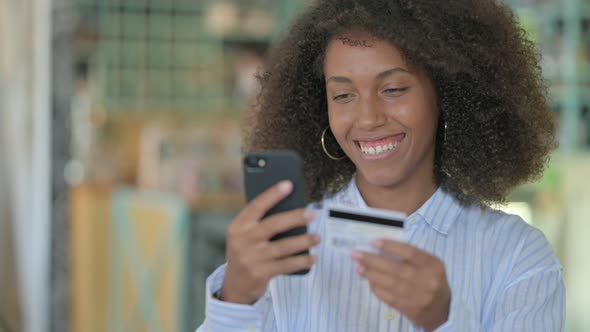 African Woman Excited for Online Shopping on Smartphone 