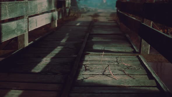 Old Wooden Bridge Over a Small Stream in a Park