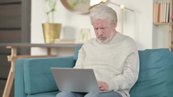 Old Man with Laptop Coughing on Sofa