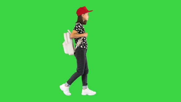 Asian Schoolgirl with Backpack Walking on a Green Screen Chroma Key