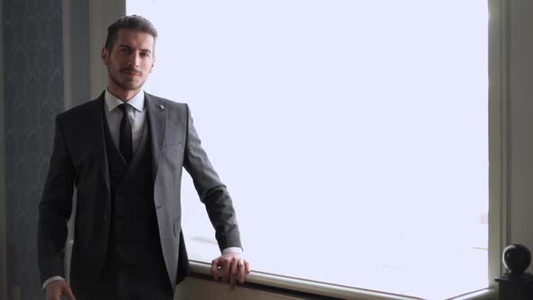 Men's Fashion and Style. Portrait of Handsome Young Groom By the Window Indoors