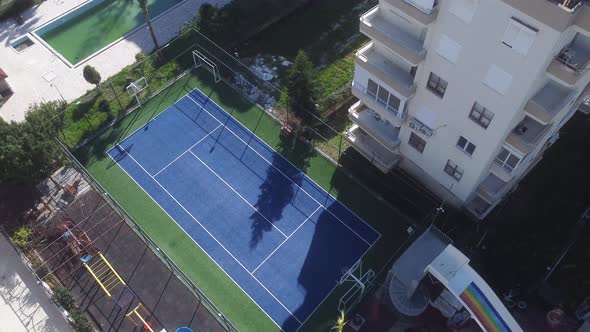 A Sports Basketball and Football Ground Next to a New Building in a Warm Resort Town Near the Sea