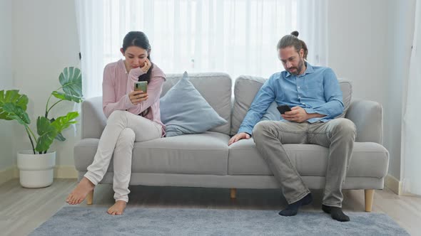 Caucasian phone addict couple don't pay attention with each other.