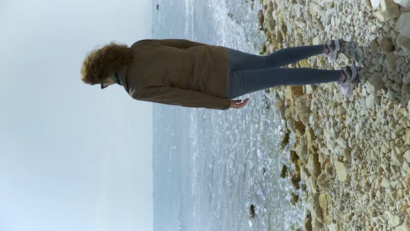 Curly Brunette Woman Looking at the Mediterranean Sea