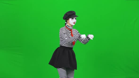 Mime Girl Riding a Scooter, Waving To Someone