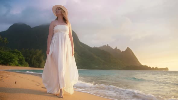 Lady Relaxing on Beach Against Beautiful Green Mountains on Background at Sunset