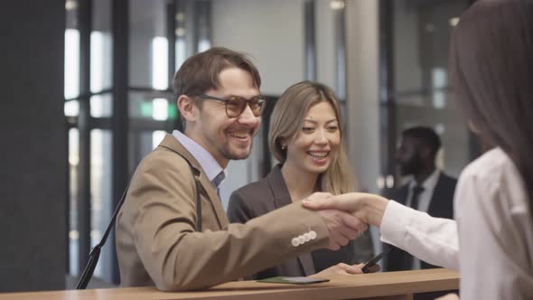 Receptionist Welcoming Guests at Hotel